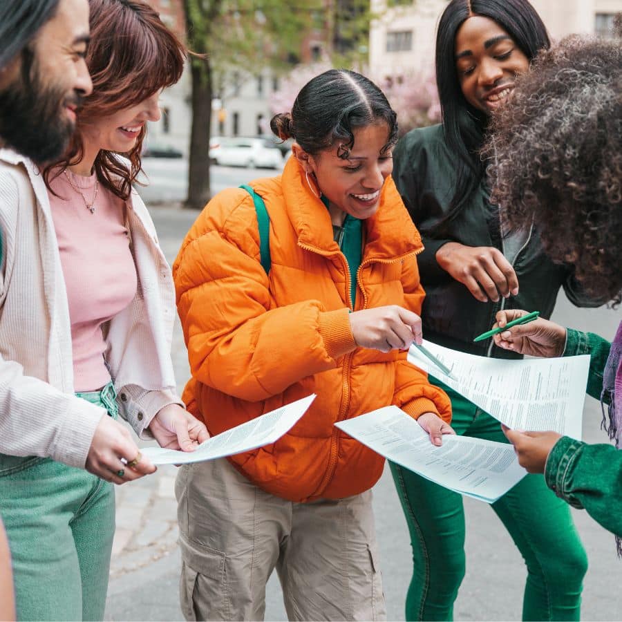 group of people looking at flyers