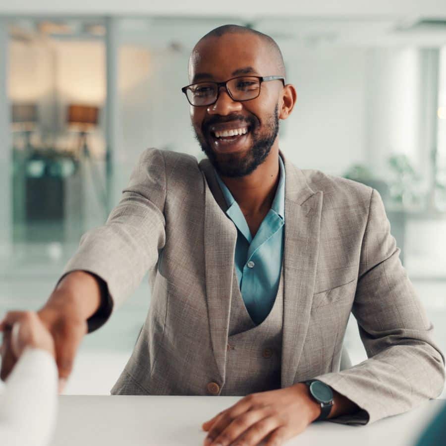 man reaching out to shake someone's hand
