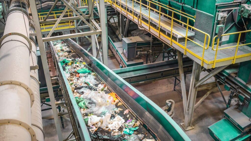 recycling plant conveyor belt with recycling products on it