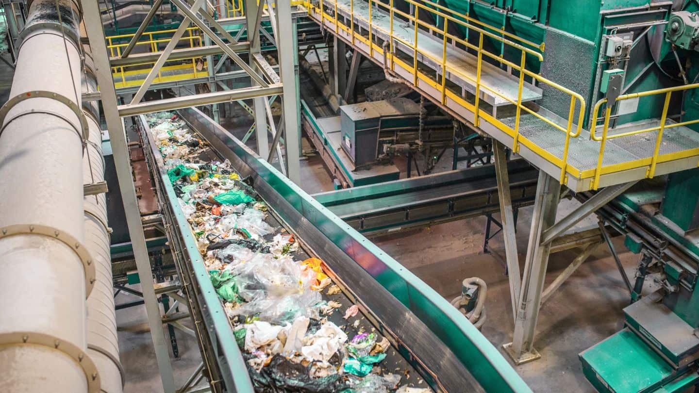 recycling plant conveyor belt with recycling products on it